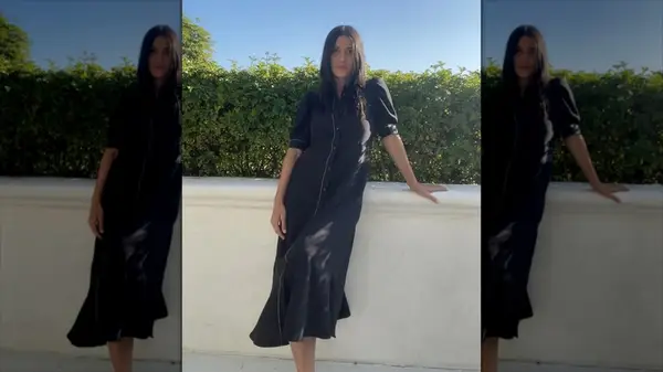 A woman in a black shirt dress