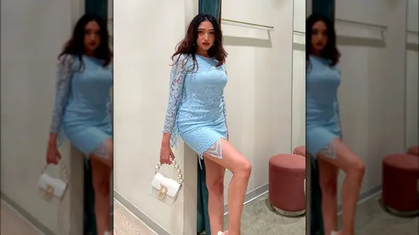 A woman in a pale blue dress 