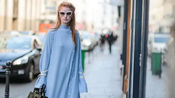 A woman in a pale blue dress 