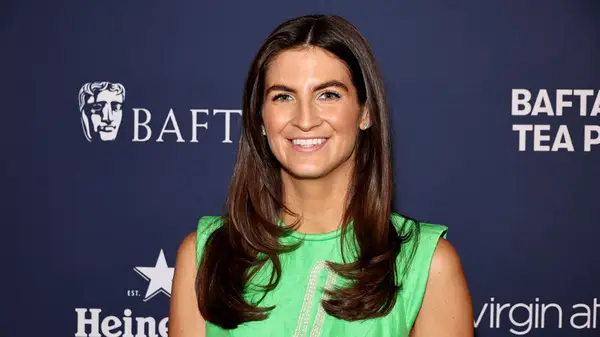 Kaitlan Collins at an event smiling at the camera wearing a lime green sleeveless dress