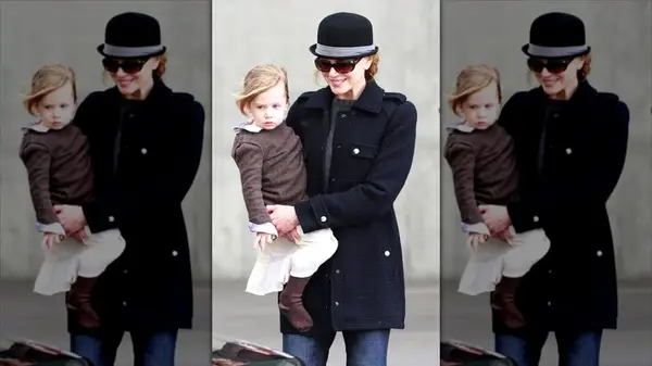 Nicole Kidman walking while carrying her daughter