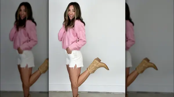 Woman posing in cowboy boots and white denim shorts