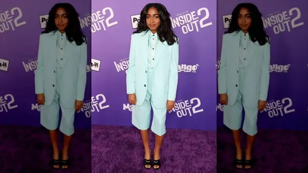 Ayo Edebiri in a short pastel blue pantsuit