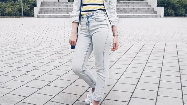 A person wearing light denim pieces
