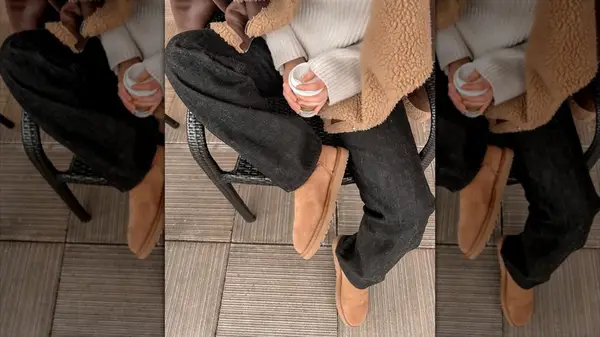 A person in washed, black denim jeans