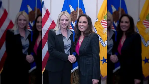Pam Bondi with in a suit shaking hands with Harmeet Dhillon