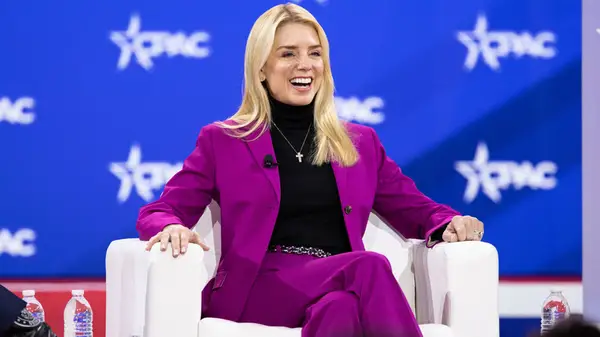 Pam Bondi in a purple suit at CPAC 2025