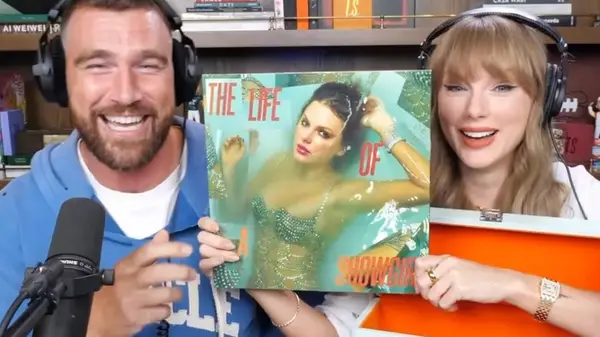 Travis Kelce and Taylor Swift holding her Life of a Showgirl album