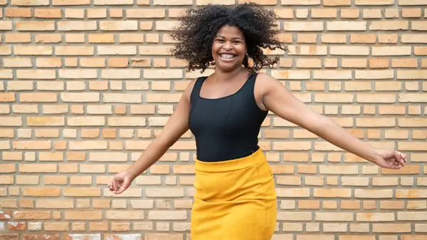 Woman in bodysuit and yellow skirt