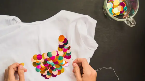 Woman sewing sequins