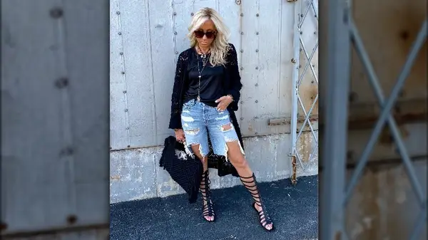 Woman with jean shorts and black gladiator sandals