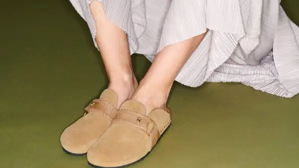 Model wearing textured pants and tan mules