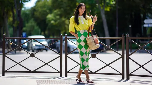 A woman wearing a bright skirt 