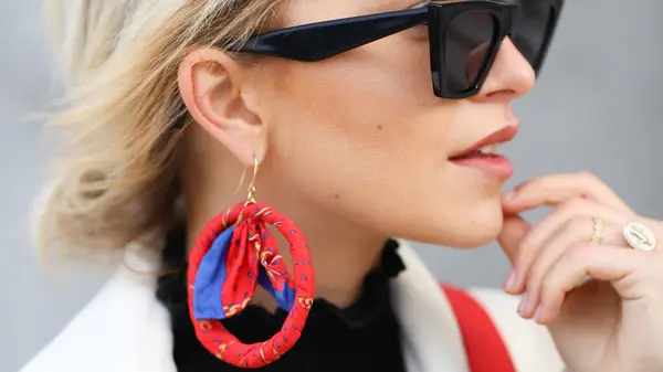 A woman with red earrings 