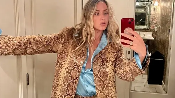 Ariel Rezek poses in a snakeskin suit