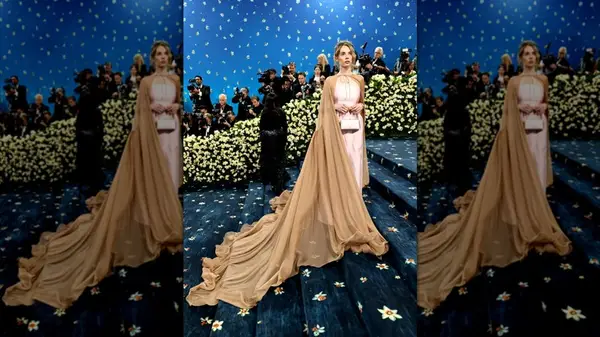 Maya Hawke on the steps of the Met Gala in a pink gown with a long cape