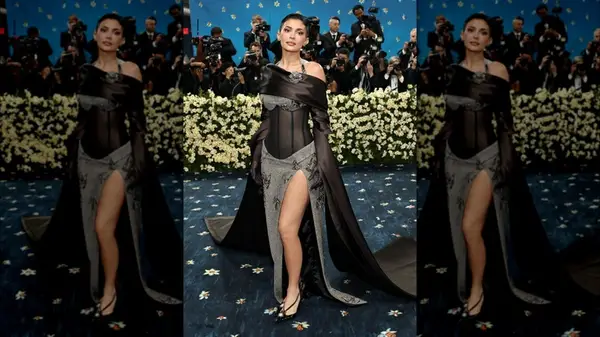 Kylie Jenner on the red carpet in a black gown with herringbone fabric details