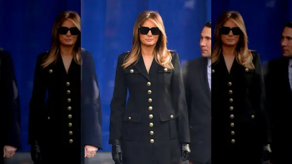 Melania Trump wearing a black suit with large gold buttons