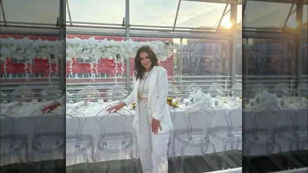 Woman wearing a white blazer, top, and pants