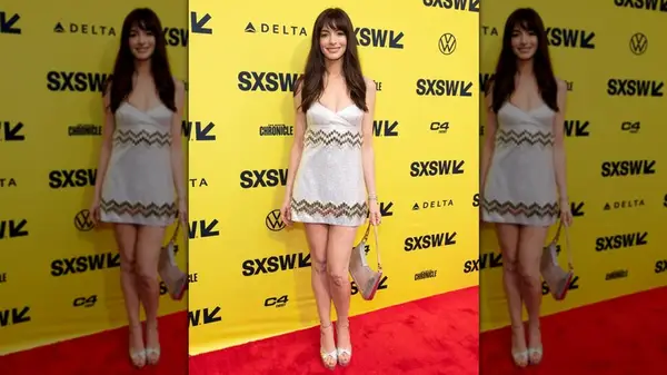 Anne Hathaway posing in a shiny mini-dress at SXSW in 2024