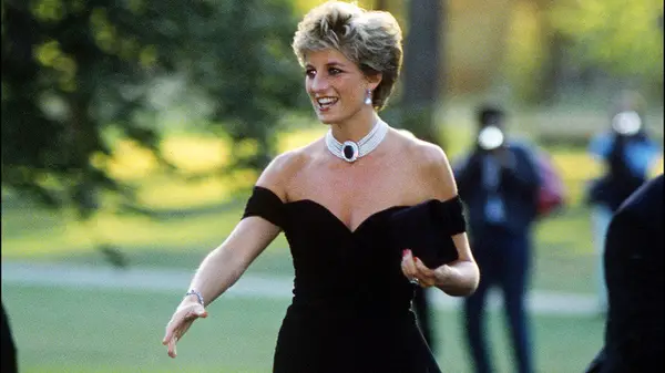 Princess Diana wearing a little black dress and shaking someone