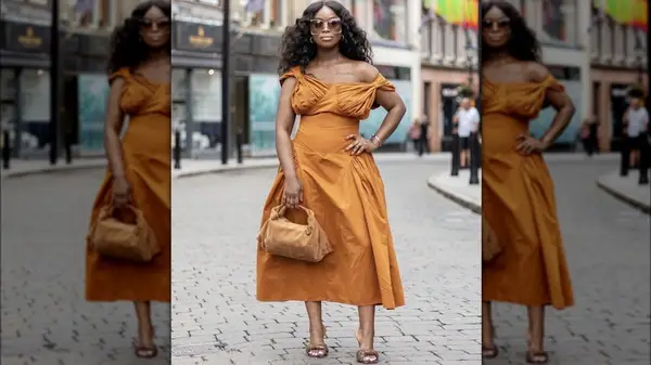 Woman wearing monochrome outfit posting on the street
