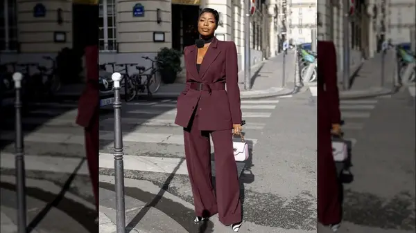 Woman posting on street wearing a suit