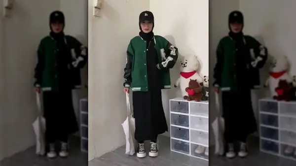 Woman in long skirt varsity jacket