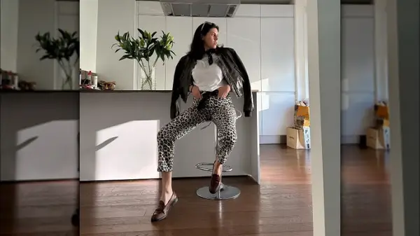 Women wearing a leather jacket and loafers