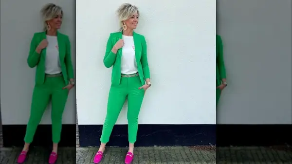 Woman wearing a bright suit and loafers