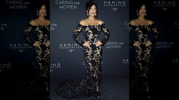 Lauren Sanchez in a sheer gown with navy blue flowers at an event