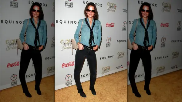 Katie Holmes on the red carpet in black jeans and a denim shirt