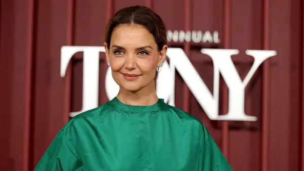 A close up of Katie Holmes in a green shirt at an event