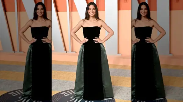Olivia Munn posing with her hands on her hips at the Vanity Fair Oscar Party