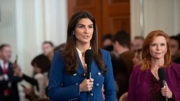 Kaitlan Collins in a blue jacket