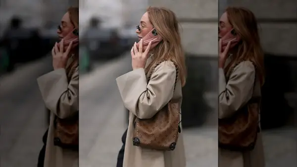 Sonia Lyson carrying a Louis Vuitton brown logo monogram pattern bucket bag with gold chain straps