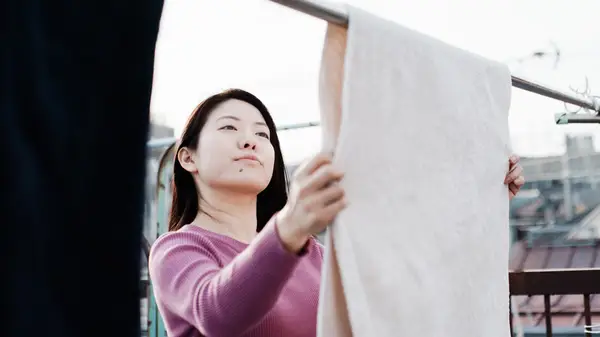 Woman hanging clothes on a washing line
