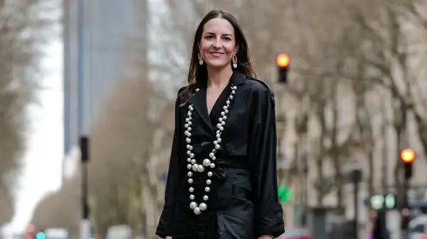 A woman wearing a long necklace 