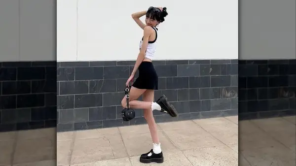 Woman posing in mini skirt and mary janes