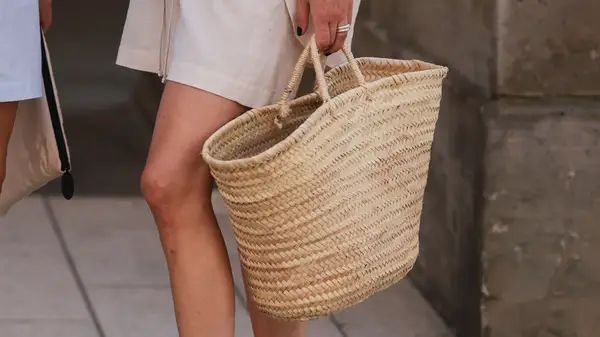 person holding bsket bag