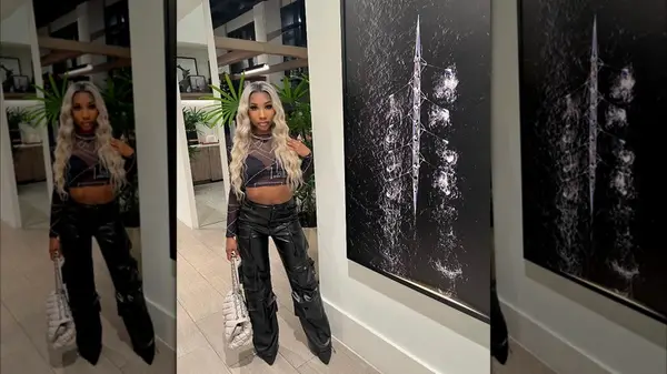 Outfit featuring vinyl cargo pants and patterned mesh top over bra