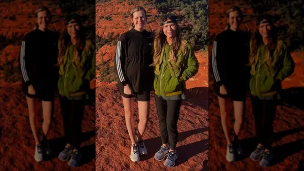 Kristi Noem wearing a backwards cap with a green jacket and sneakers