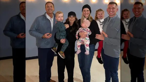 Kristi Noem posing with her family in an all-black outfit