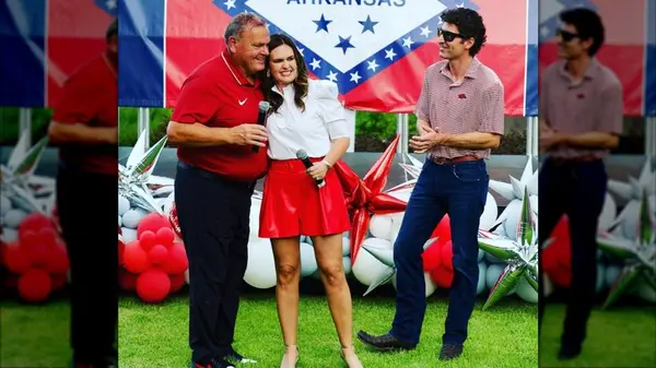 Sarah Huckabee Sanders with husband and another man at an event