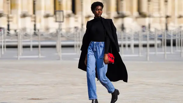A woman in a long black coat 