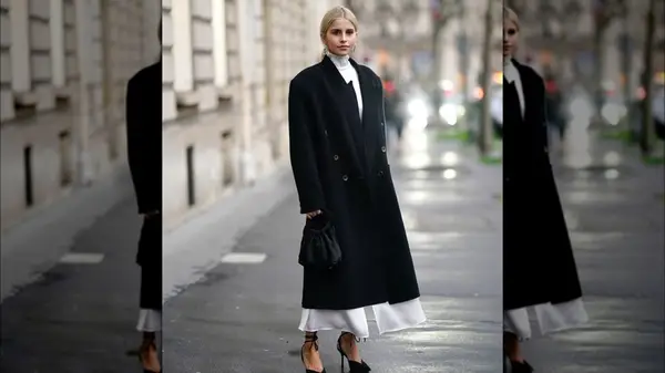 A woman in a long black coat 