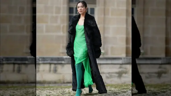 A woman in a long black coat 