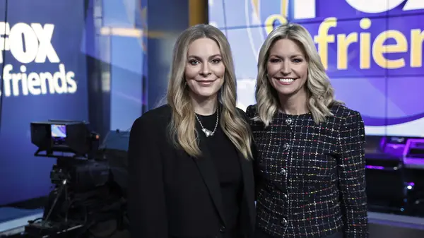 Ainsley Earhardt with Leah McSweeney on Fox & Friends with Earhardt wearing a black boucle jacket