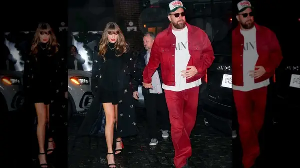 Taylor Swift in a black dress with Travis Kelce in a red tracksuit