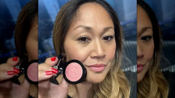 Woman holding powder blush
